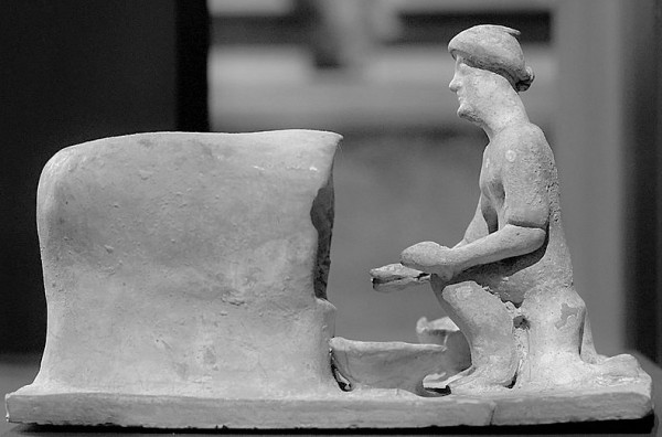 5th century BC sculpture of woman baking bread